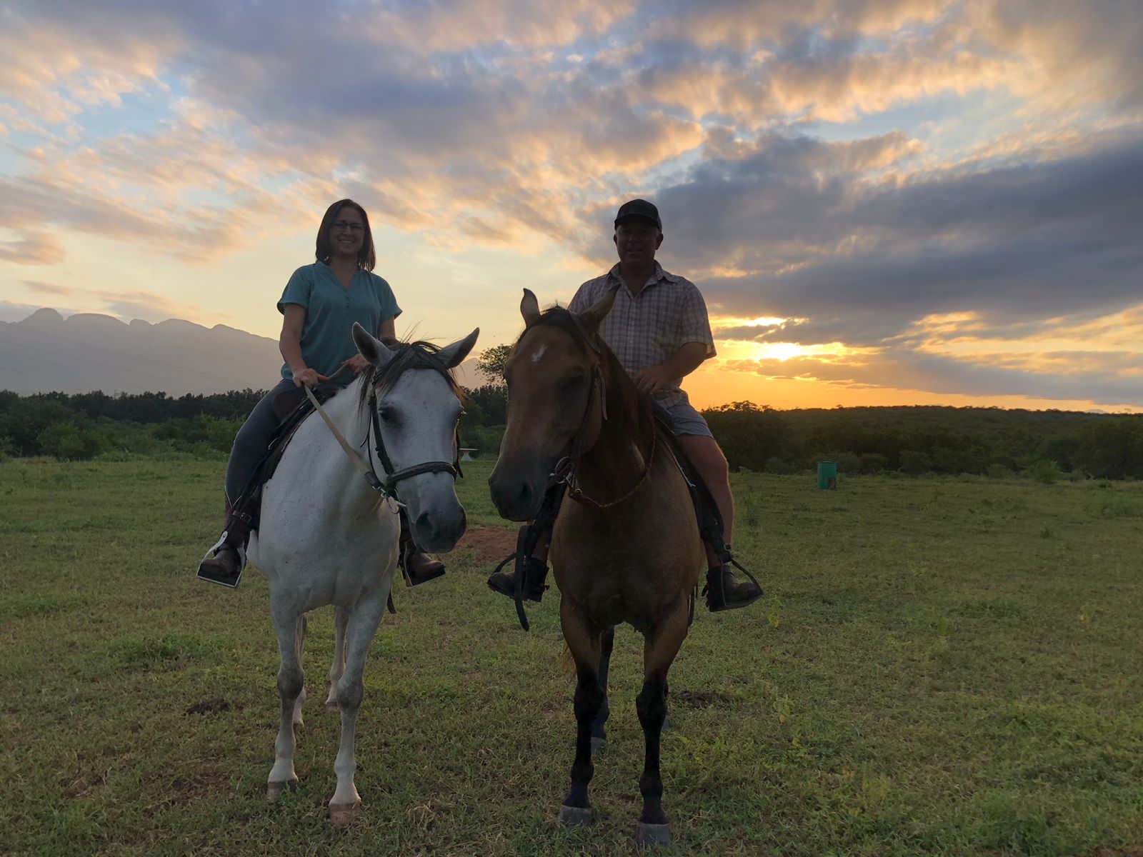 Two riders at sunset on Nimble Drift horses